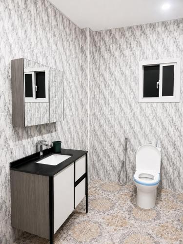 a bathroom with a sink and a toilet in it at Peace apartment in Brufut