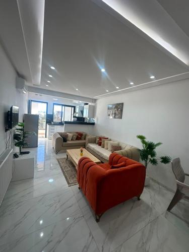a living room with a red couch in a room at Appartement de luxe in Tunis