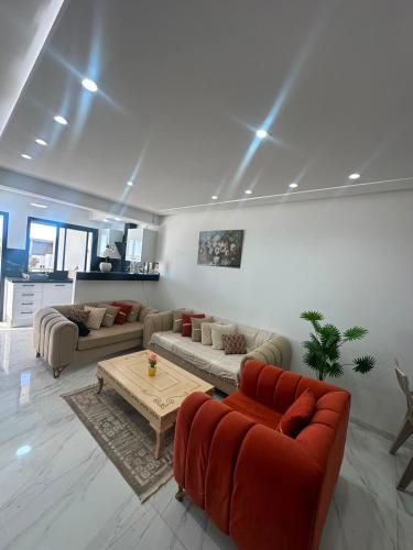 a living room with two couches and a coffee table at Appartement de luxe in Tunis