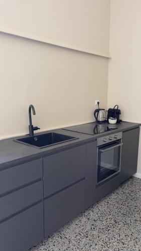a kitchen with a sink and a stove at Residenze Candida - Casa Bianca in Locri