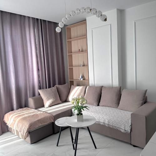 a living room with a couch and a table at Joel Family Apartment's Golem Center in Golem