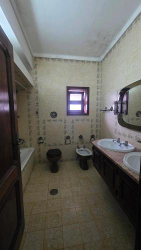 a bathroom with two sinks and a toilet and a tub at Oliveirinha, Aveiro, Portugal in Oliveirinha