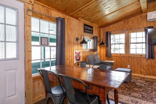 a dining room with a wooden table and chairs at Historic Rockaway Beach Cottage 12 in Rockaway Beach