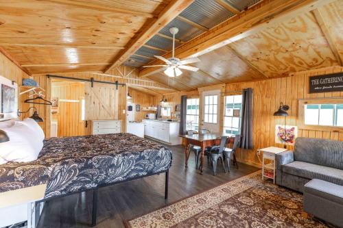 a bedroom with a large bed and a kitchen at Historic Rockaway Beach Cottage 12 in Rockaway Beach