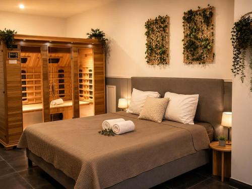a bedroom with a bed with two towels on it at Wellness Suite Zeist in Zeist