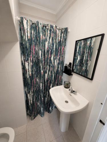 a bathroom with a sink and a shower curtain at Villa Richmond in Gran Alacant
