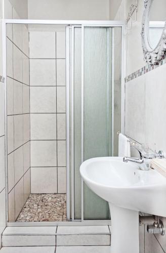a bathroom with a sink and a shower at Rundu B&B in Rundu