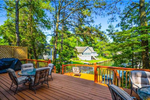 a wooden deck with a table and chairs on it at Drawbridge Rd 38 in Ocean Pines