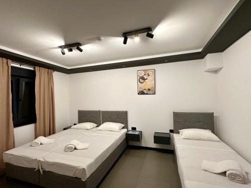 two beds in a room with white walls at Prenoćište Vozač in Jajce