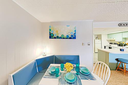 a kitchen with a table with blue dishes on it at Colonial Unit 202 in Ocean City