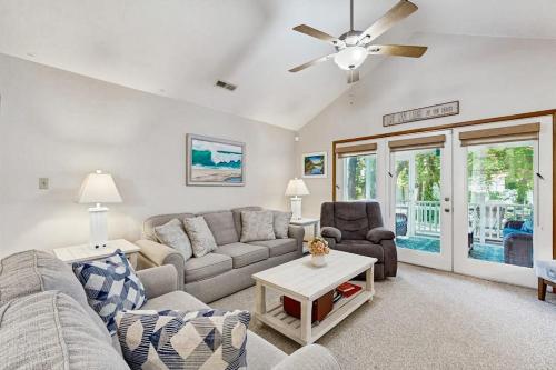 a living room with a couch and a ceiling fan at Sunny Day in Ocean City