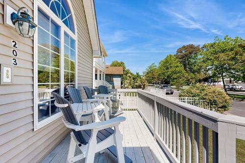 a porch with rocking chairs on the side of a house at Sunny Day in Ocean City