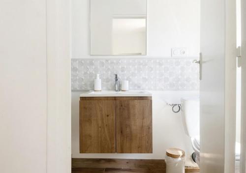 a bathroom with a sink and a toilet at L'Opale in Roanne