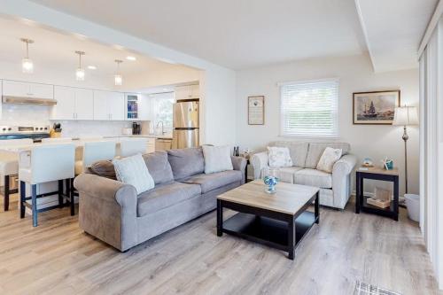 a living room with a couch and a table and a kitchen at 14 Clipper on the Bay in Ocean Pines