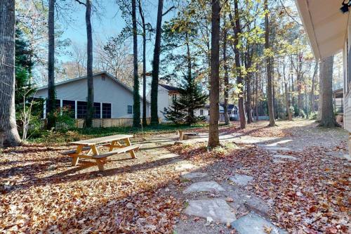 a picnic table in a park with trees and leaves at 5 Whitecap in Ocean Pines