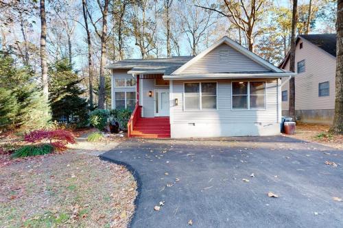 a white house with a red door and a driveway at 5 Whitecap in Ocean Pines