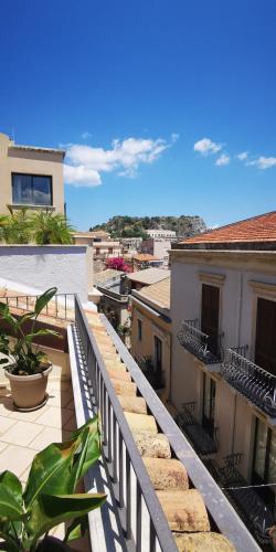 a balcony with a fence and some buildings at Donna Rosa - Main Avenue in Taormina