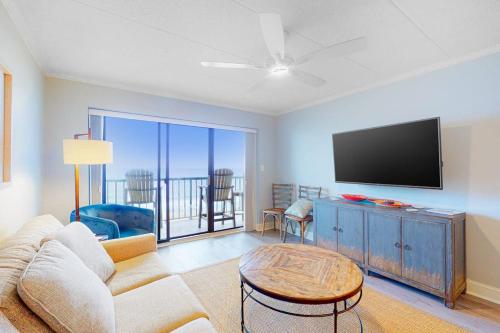 a living room with a couch and a flat screen tv at Summer Beach 602 in Ocean City