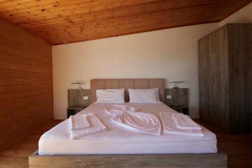 a bedroom with a bed with two towels on it at Shengjin villa in Shëngjin