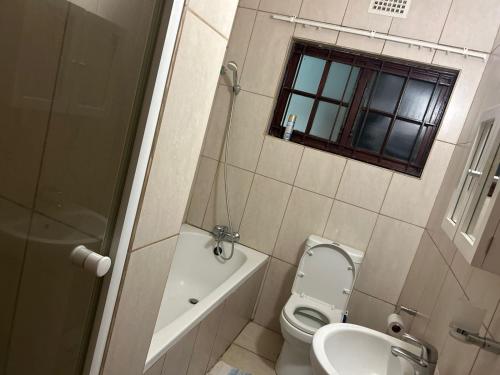 a small bathroom with a toilet and a sink at Eden Wilds 42 in Port Edward