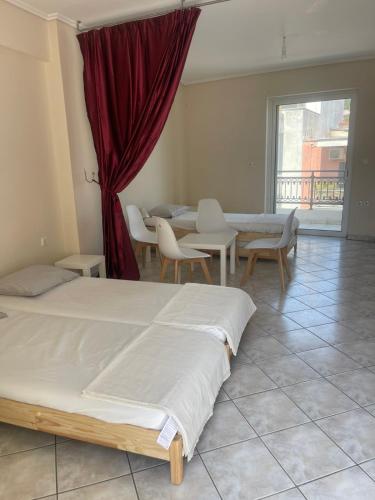a bedroom with a bed and a table and chairs at RRooms in Nafpaktos