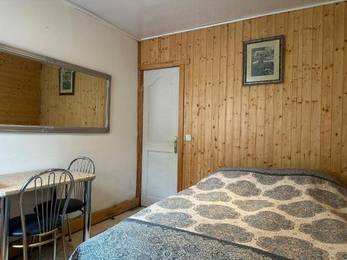 a bedroom with a bed and a table and a mirror at Magdelena in Palanga