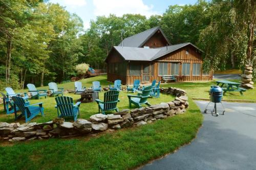 a group of blue chairs and a log cabin at The Luxury Cabin at Deep Hollow in Narrowsburg