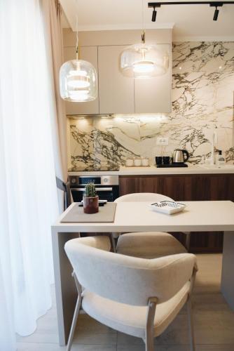 a kitchen with a white table and a chair at Villa Harmonia in Glavati