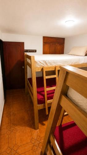 a room with two bunk beds and a table at Morada Living Bello HomeStay in Bello