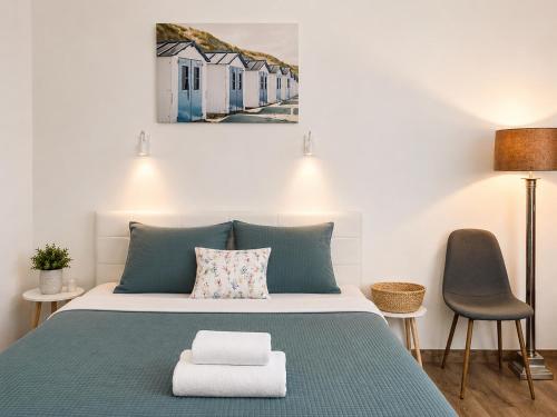 a bedroom with a bed and a chair at Esther's Studio Keszthely in Keszthely