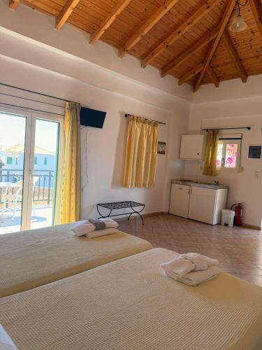 a bedroom with a bed with two towels on it at Sunset elafonisos in Elafonisos