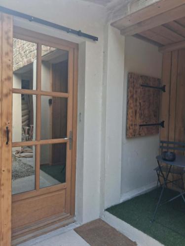 a wooden door of a house with a window at studio in Saint-Georges-de-Luzençon
