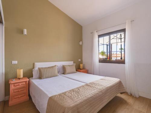a bedroom with a large bed and a window at Sunny Haven I in Maspalomas