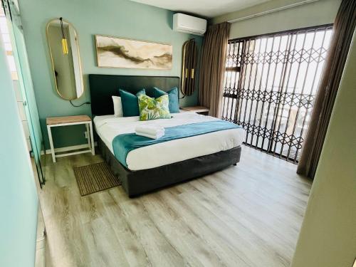 a bedroom with a large bed and a window at Hyde Park in Durban