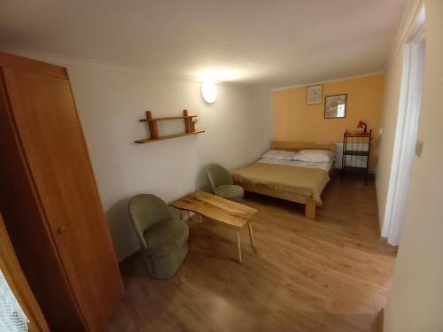 a small room with a bed and a table at Pod lasem domek letniskowy in Susiec