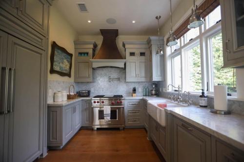 a kitchen with white cabinets and a stove top oven at Playa Penthouse (Ocean Views) in Carpinteria