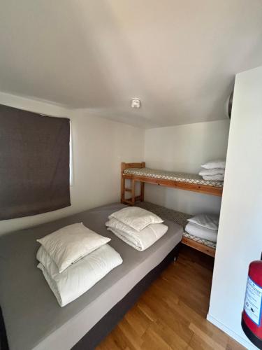 a bed in a room with two pillows on it at Røldal Overnatting in Røldal