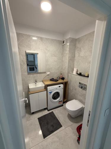 a bathroom with a washing machine and a sink at Apartment in Ploiești 3 in Ploieşti