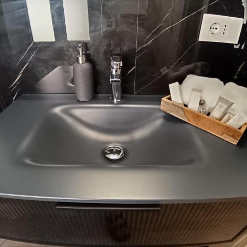 a sink in a bathroom with soap and toiletries at Appartamento centro storico in Viverone