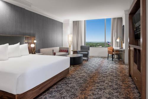 a hotel room with a large bed and a large window at Horseshoe Tunica Hotel & Casino - A Caesars Rewards Destination in Tunica Resorts