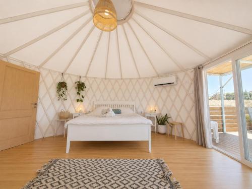 a bedroom with a white bed in a tent at Moonlight Suite Arad צימר אור הירח, ערד in Arad