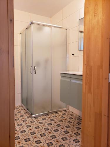 a shower in a bathroom with a tile floor at Moonlight Suite Arad צימר אור הירח, ערד in Arad