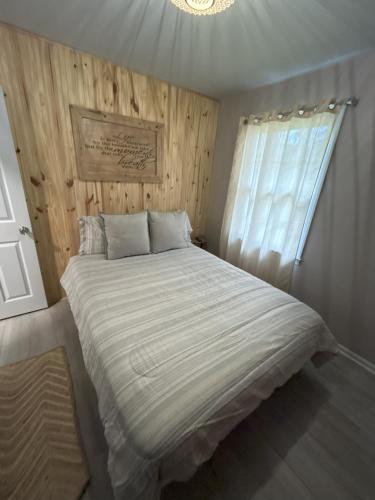 a bedroom with a large bed with a window at Robin's Nest Savannah in Savannah