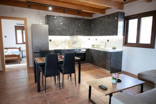 a kitchen and living room with a table and chairs at Mulberry Tree House in Póndi