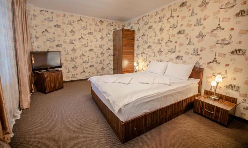 Un pat sau paturi într-o cameră la Europa Hotel
