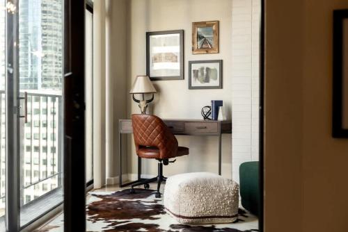 a room with a desk and a chair and a window at Urban Gallery Loft - King Bed - Larimer Square in Denver