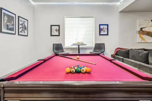 a pool table with balls on it in a living room at Modern Elegance - Pool Table - Walkable Area in Aurora