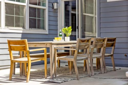 a wooden table and chairs on a patio at Modern Elegance - Pool Table - Walkable Area in Aurora