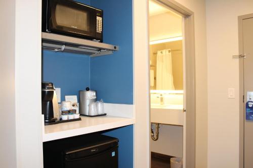 a kitchen with a sink and a microwave at Holiday Inn Express Bakersfield by IHG in Bakersfield