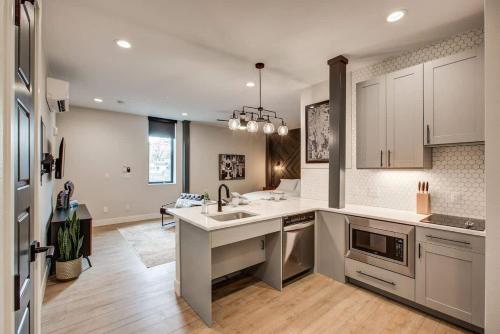 a kitchen with a sink and a counter top at Modern ADA-Accessible Studio - Tennyson St Escape in Denver